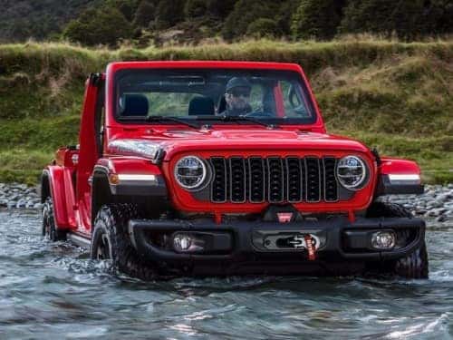 2023 Jeep 4xe driving across a stream