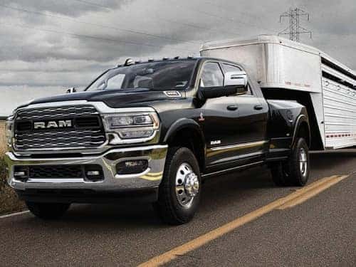 2024 RAM 3500 driving down the road towing a trailer
