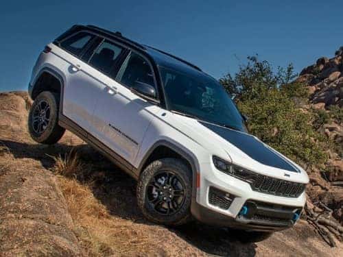 2024 Jeep Grand Cherokee driving down a rocky hill