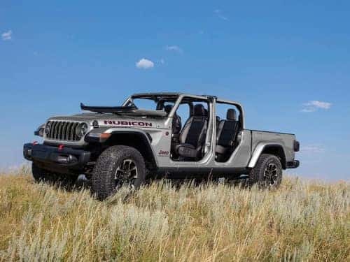2024 Jeep Gladiator parked on a grassy hill with doors off