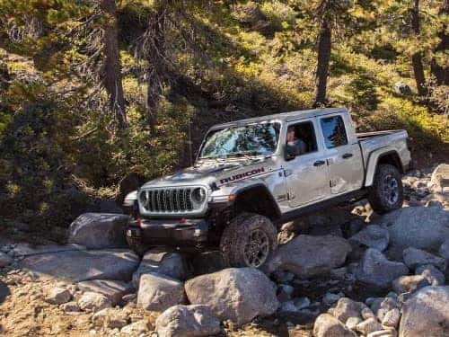2024 Jeep Gladiator offroading over rocky terrain