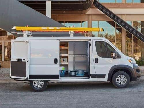 2024 RAM ProMaster side exterior view with side door open showing cargo area full of tools