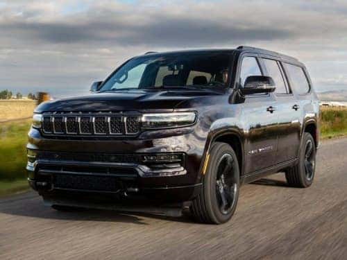 2024 Grand Wagoneer Obsidian Package driving down a road