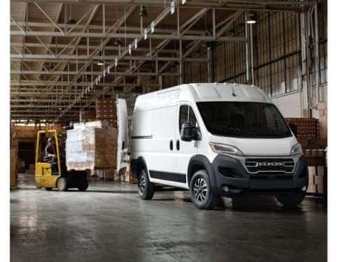 2025 RAM ProMaster view of man loading pallet into cargo of van