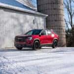 2025 GMC Terrain in Volcanic Red Tintcoat parked on scenic overlook