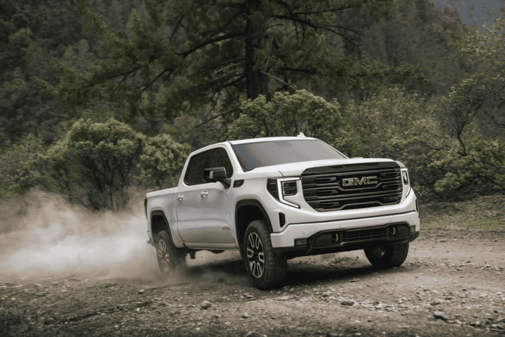 Front view of the 2025 GMC Sierra 1500 AT4 driving off-road