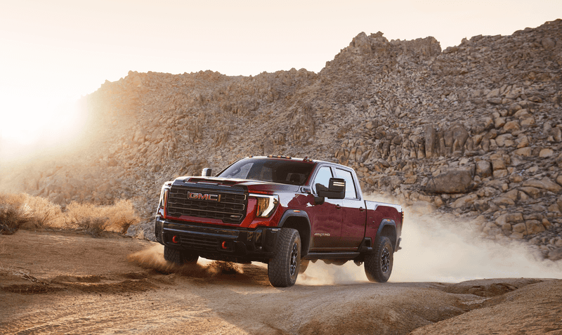 A 2026 GMC Sierra HD pickup truck in the new Coastal Dune paint color parked near the coast in Vero Beach, Florida.