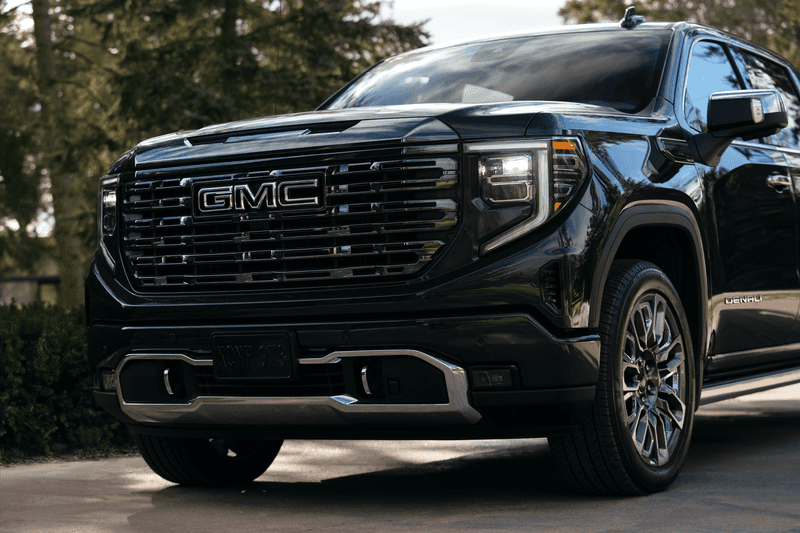 A new 2026 GMC Sierra 1500 AT4 pickup truck in the stunning Glacier White Tricoat, parked on a coastal road near Vero Beach, Florida.