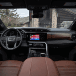 The luxurious full-grain leather interior of the 2026 GMC Sierra 1500 Denali Ultimate, showcasing the 13.4-inch touchscreen and digital cluster.