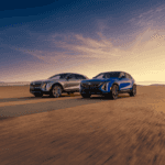 2025 Cadillac Lyriq in Argent Silver Metallic parked in front of modern architecture