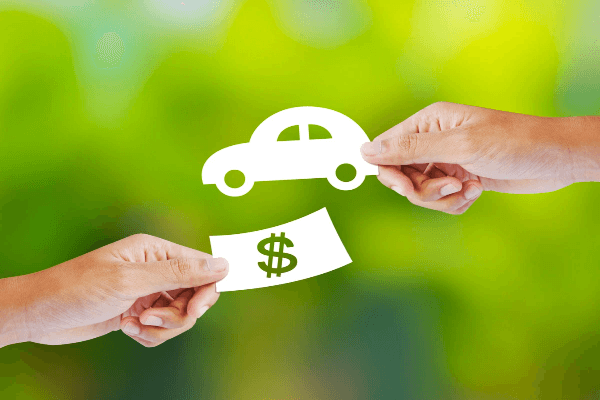 A man dropping a set of car keys into a woman's hand.