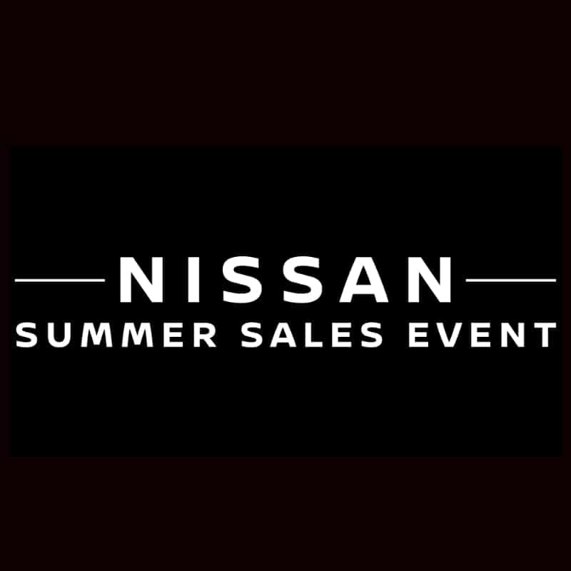 A front facing red Nissan car