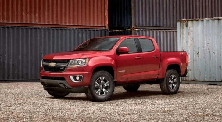 A red 2019 Chevy Colorado Z71 is shown parked near shipping containers.