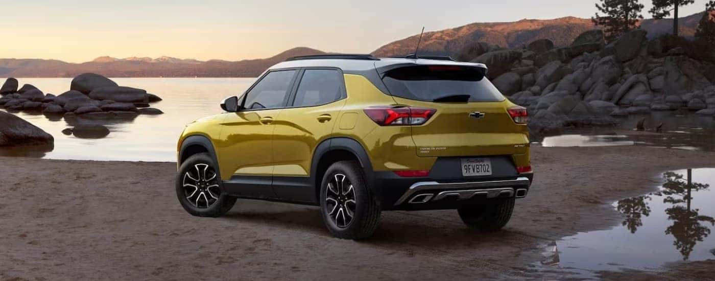 A yellow 2021 Chevy Trailblazer ACTIV is shown parked on a shore.