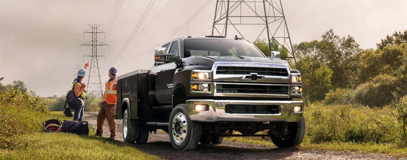 A black 2024 Chevy Silverado 5500 for sale parked under power lines.