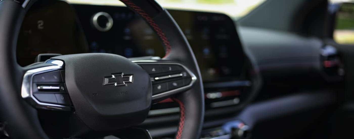 A close-up of the steering wheel is shown in a 2025 Chevy Silverado EV for sale near Advance.