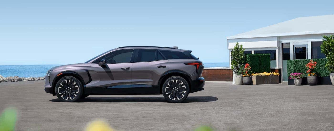 A grey 2025 Chevy Blazer EV parked on gravel.