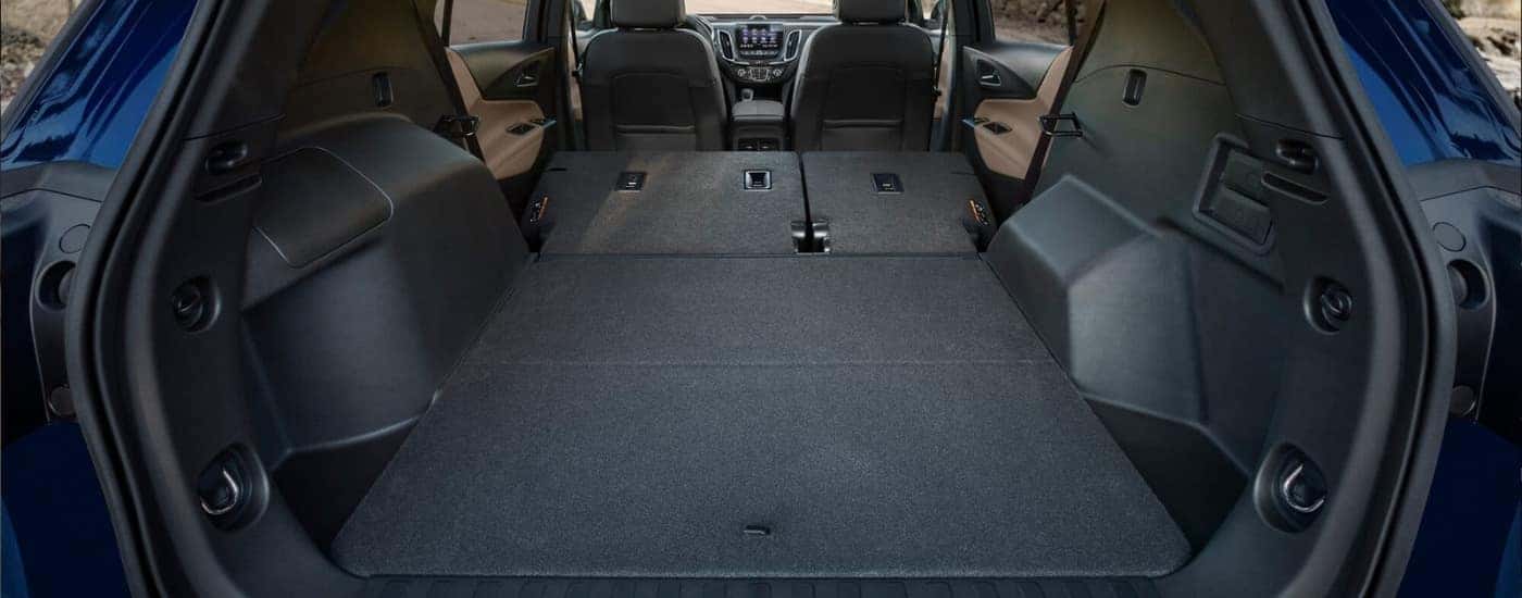 Rear cargo area in a blue 2023 Chevy Equinox.
