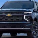 A black 2025 Chevy Tahoe High Country parked near water