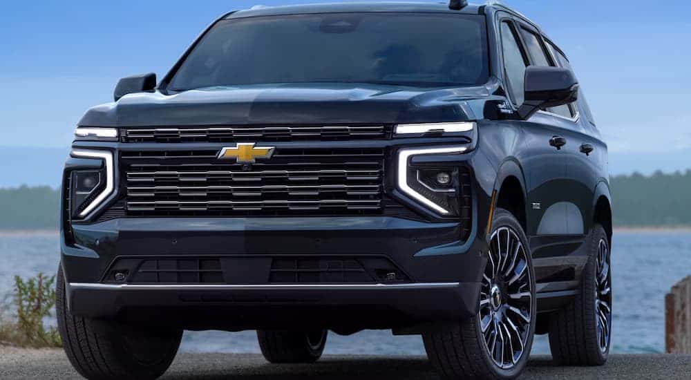 A black 2025 Chevy Tahoe High Country parked near water