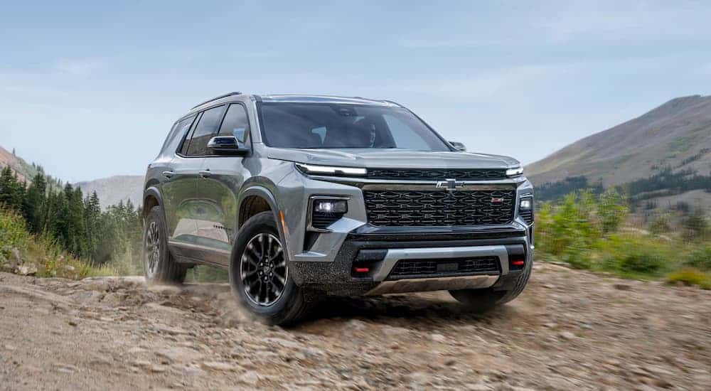 A silver 2025 Chevy Traverse for sale parked off-road