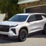 A white 2025 Chevy Traverse parked in a driveway