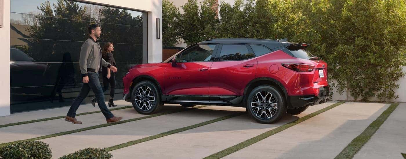 A red 2023 Chevy Blazer from the side after leaving a dealer that has a used Chevy for sale near Hampstead.