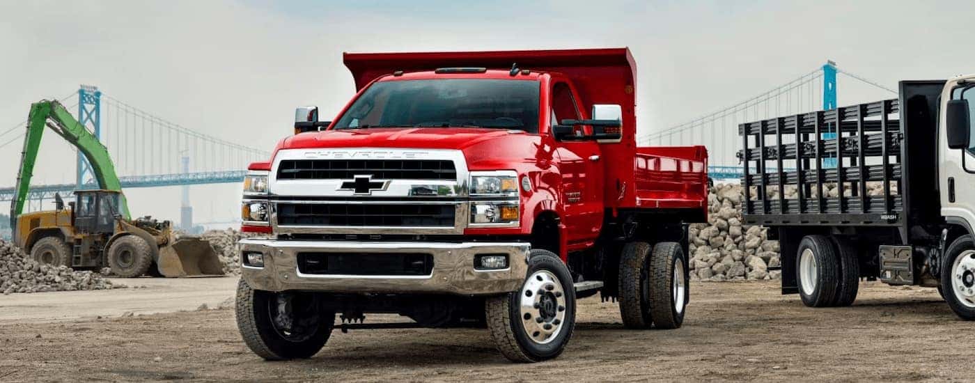 Red 2025 Chevy Silverado 6500 parked at a construction site.