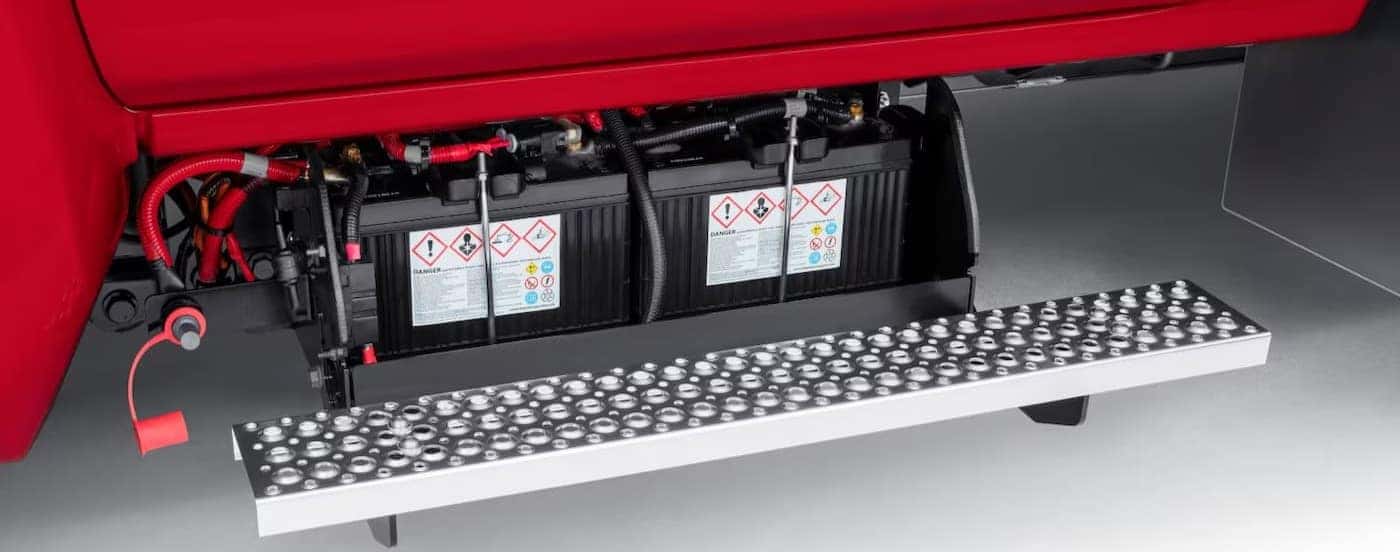 Close-up of battery storage on a red 2025 Chevy Silverado 6500.
