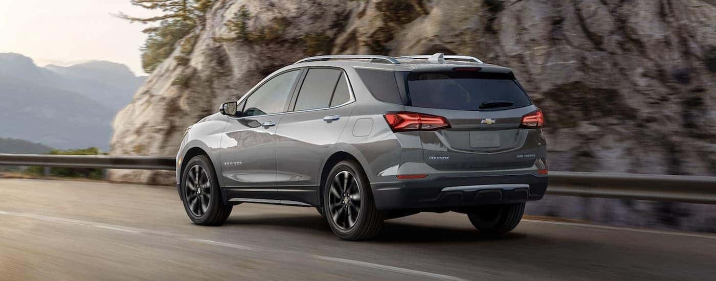 A silver 2023 Chevy Equinox driving to view a used Chevy for sale near Advance.