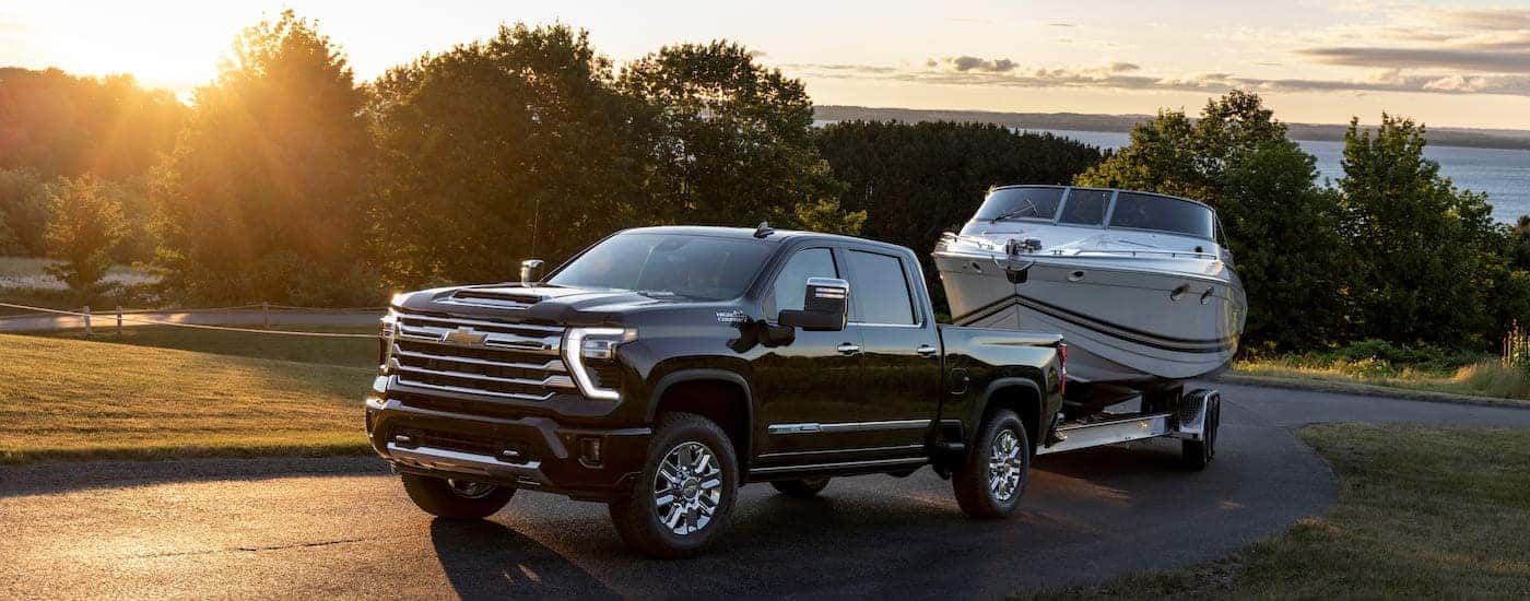 A black 2024 Chevy Silverado 2500 HD from the front after leaving a dealer that has a used Chevy for sale near Greensboro.