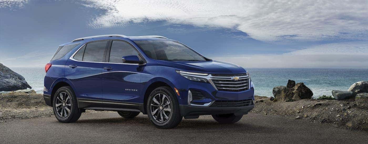 A blue 2022 Chevy Equinox Premier from the side.