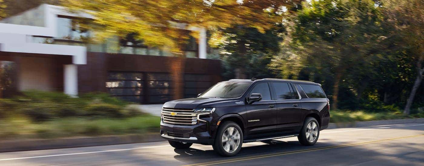 A grey 2025 Chevy Suburban from the side.