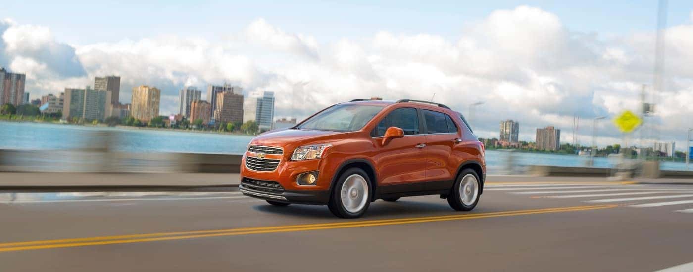 An orange 2016 Chevy Trax from the side after leaving a dealer that has a used Chevy for sale near Winston-Salem.