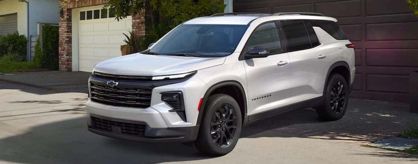 A white 2025 Chevy Traverse parked on a driveway.