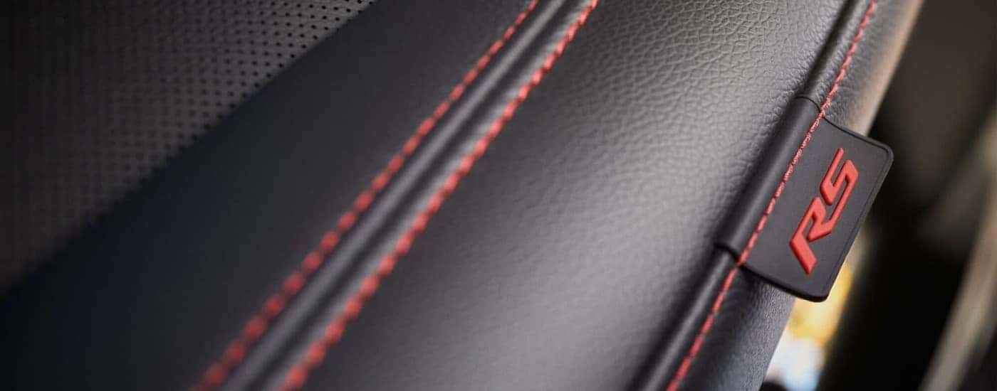 Black leather seat with red stitching in a 2024 Chevy Equinox RS.