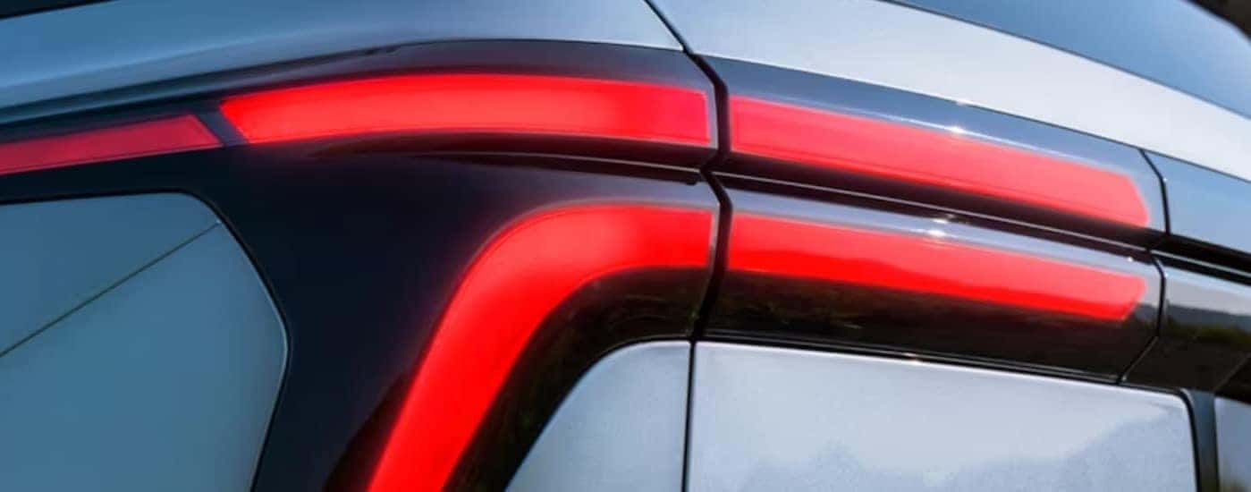 Close-up of a taillight on a silver 2025 Chevy Traverse.