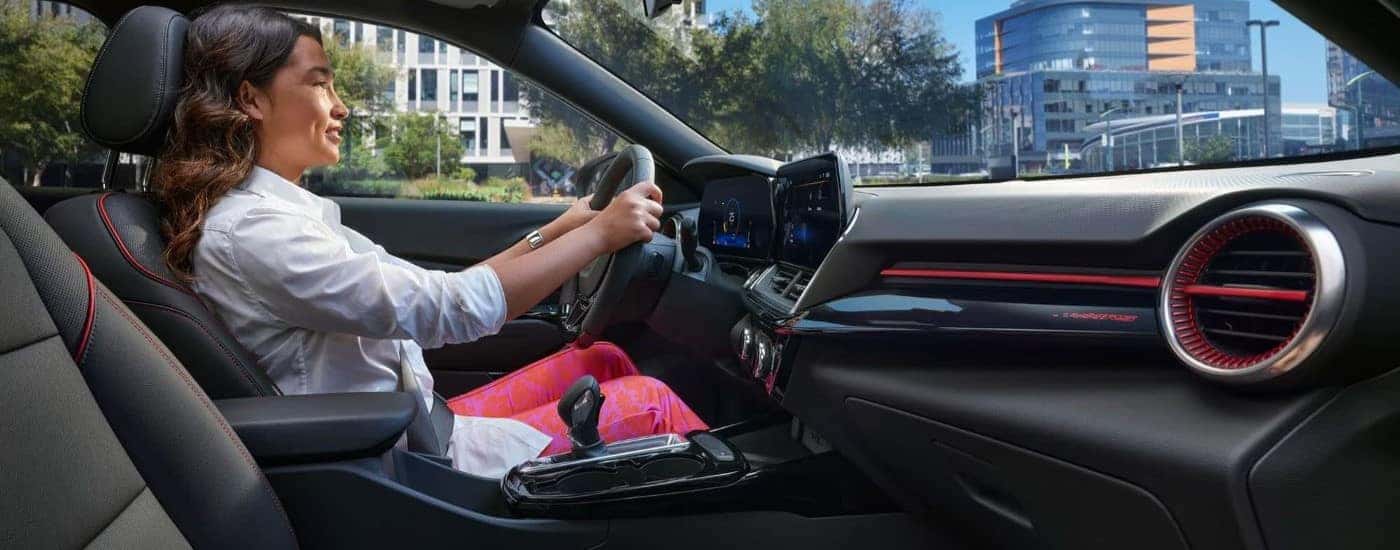 A woman driving a 2024 Chevy Trax RS for sale near Advance