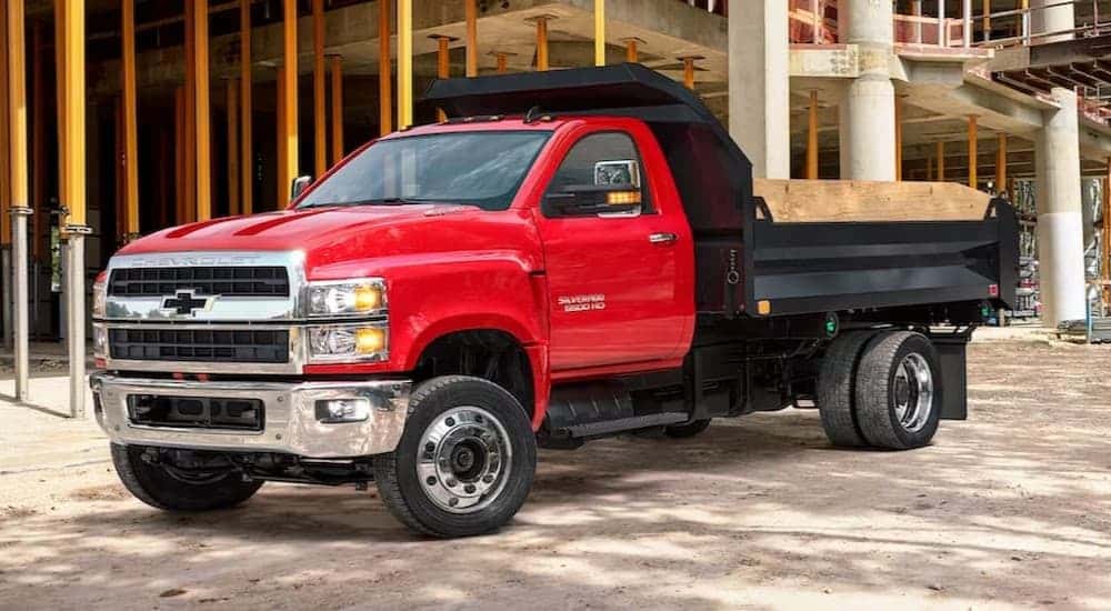 A red 2020 Chevy Silverado 6500 parked on a construction site.