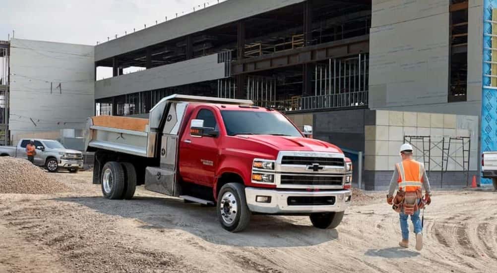 A red 2024 Chevy Silverado 5500 parked on a construction site.