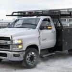A white 2025 Chevy Silverado 4500 parked on a construction site.