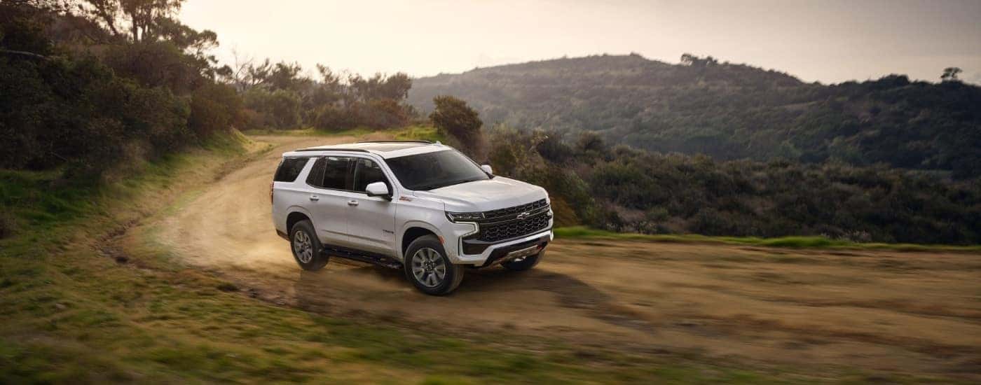 A white 2022 used Chevy Tahoe for sale from the side.