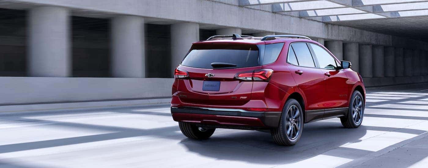 A red 2023 Chevy Equinox from the rear.
