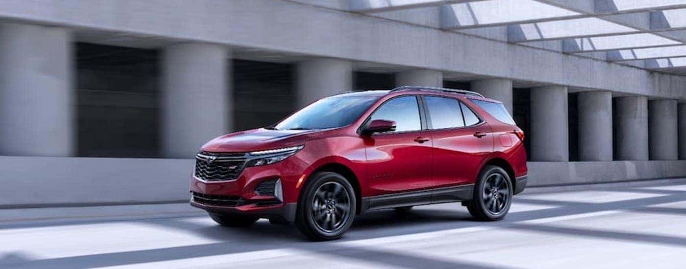 A red 2025 Chevy Equinox from the side.