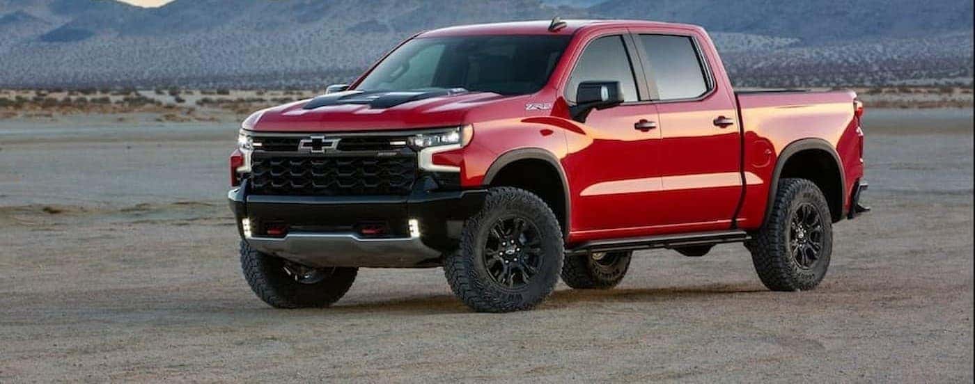 A red 2022 Chevy Silverado 1500 ZR2 for sale parked off-road.