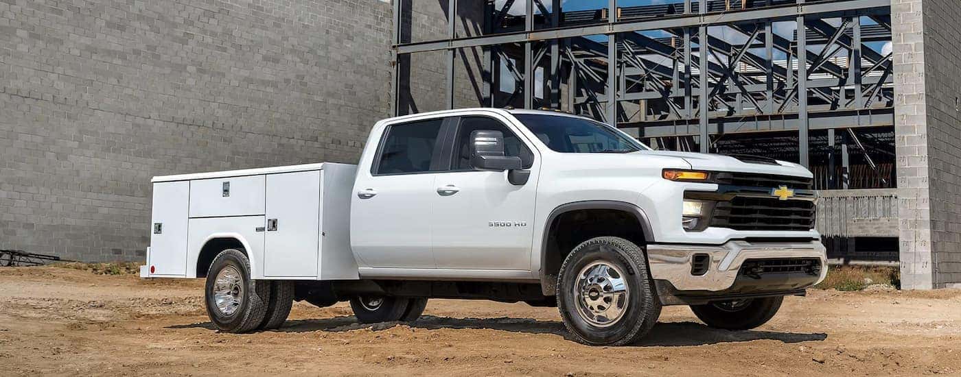 A white 2026 Chevy Silverado 3500 HD Commercial truck parked at a jobsite