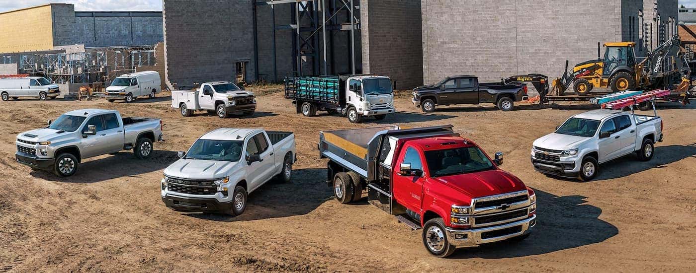 Various 2026 Chevy Commercial Vehicles parked at a jobsite