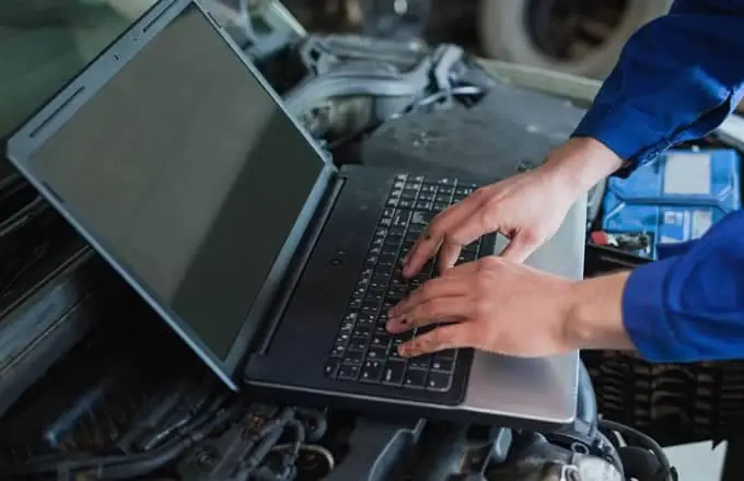 service technician running diagnostics on laptop