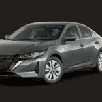 Grey Car with silver rims and black decails against a sleek black back drop