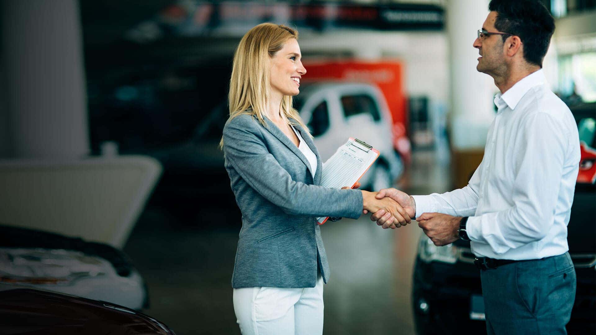 Portrait of a happy customer purchasing a new car